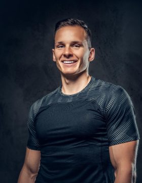 smiling-athletic-man-black-background